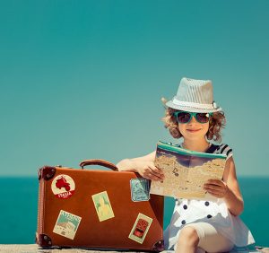 woman with vintage suitcase and city map on vacation