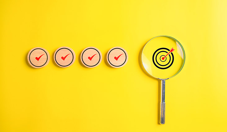 A series of checkmarks followed by a target with an arrow in it surrounded by a magnifying glass.